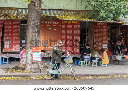Hanoi, Vietnam - Mar 15, 2015: Front view of a Sim card and newspaper stall on Ly Thai To street, near Hoan Kiem lake. The \