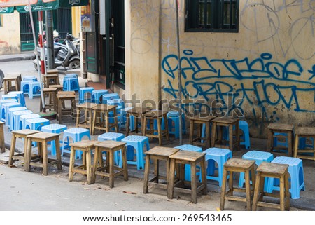 Hanoi, Vietnam - Apr 5, 2015: Lines of seats waiting for people in a coffee street stall in Luong Ngoc Quyen street. Drinking on sidewalk is typical cultural in Hanoi