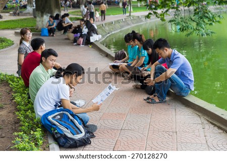 Hanoi, Vietnam - Apr 5, 2015: Group of students learn English at Hoan Kiem lake, center of Hanoi