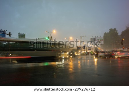 Hanoi, Vietnam - June 6, 2015: Traffic in Hanoi in the rain at twilight