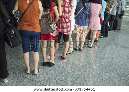 Line of airline Asian passenger waiting at boarding gate