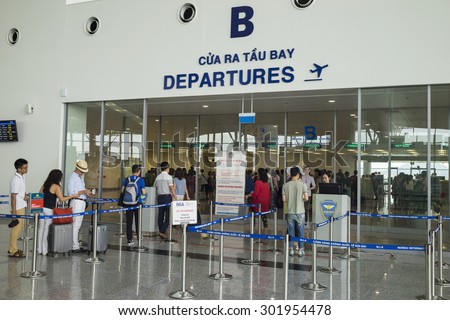 Hanoi, Vietnam - June 26, 2015: Line of people queue at departure gate at Noi Bai International Airport
