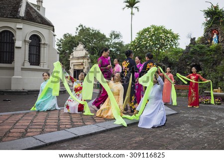 Ninh Binh, Vietnam - May 16, 2015: Vietnamese Christian women perform an old traditional dance on \