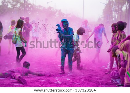 Hanoi, Vietnam - Sep 23, 2015: Well covered clothing camera man at public color run event in Hanoi capital city. Hundreds of people joined the joyful race named \