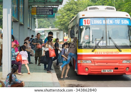 Hanoi, Vietnam - Oct 25, 2015: People boarding bus at station in Hanoi city