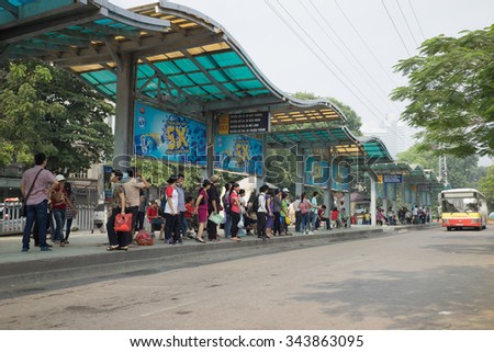 Hanoi, Vietnam - Oct 25, 2015: Line of people waiting for bus at bus station in Hanoi city