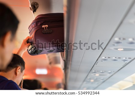 Baggage is pulling out of cabin on airplane