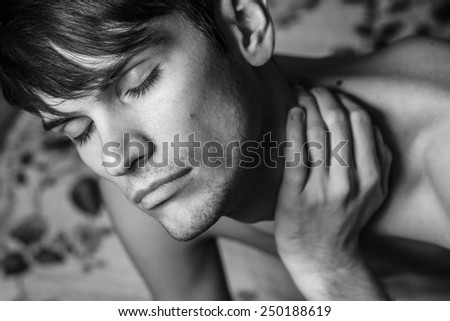 Close up of male arm. Holding on the shoulder. Black and white portrait.
