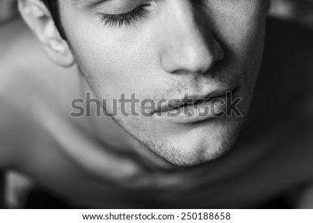 Close up of male part of face. Eyes closed. Black and white portrait.