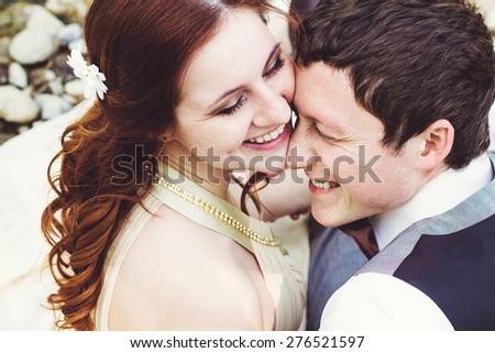 Portrait of beautiful young laughing husband and wife.