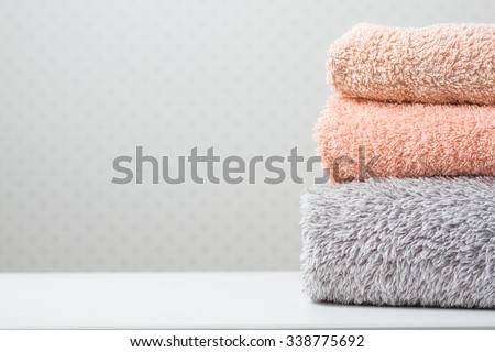 Bath towels of different colors on light background