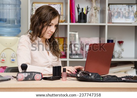 Consultant working in the cosmetics laptop