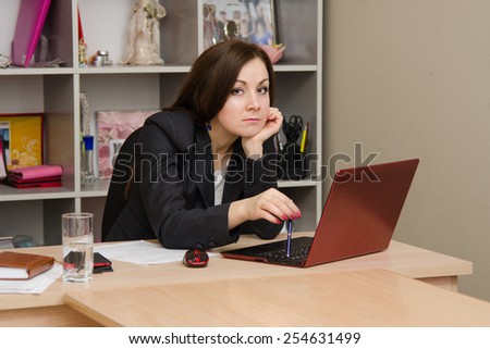 Sad girl at computer prints the document
