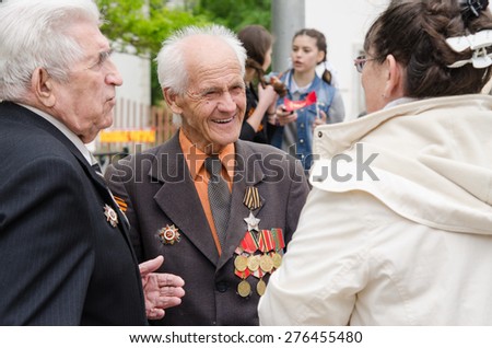 Volgograd, Russia - may 07, 2015: Veterans communicate with passers-by at a gala event