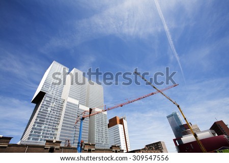 Construction site in Rotterdam, in the Netherlands, with modern architecture and old warehouses in the background