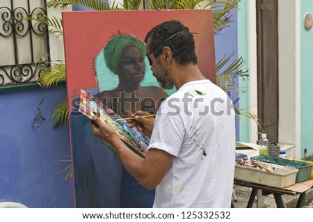 SALVADOR, BRAZIL- DECEMBER 8: Unidentified street artist paints an african woman portrait on December 8, 2012 in Salvador, Brazil. African culture is kept alive in the Bahia state of North Brazil.