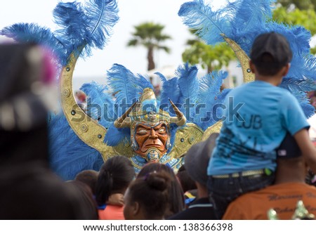 SANTO DOMINGO, DOMINICAN REPUBLIC - MARCH 3: People of all ages partying and dancing with costumes celebrating the 2013 national carnival on March 3, 2013 in Santo Domingo, Dominican Republic.