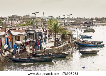 CAP-HAITIEN, HAITI - NOV 17, Unidentified people on their daily life by Mapou river after the devastation and poverty left in part by the 2010 earthquake on November 17, 2013 in Cap-Haitien, Haiti.