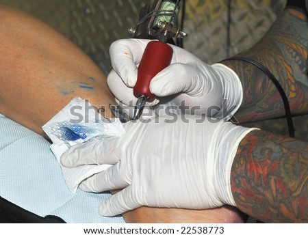 Making a Tattoo. arms. artist
