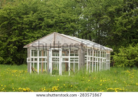Old greenhouse on the farm made of wood window frames