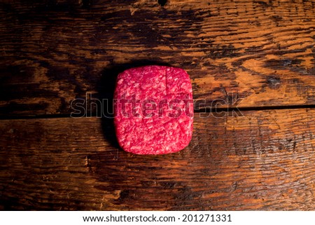 Ground beef on wood table.