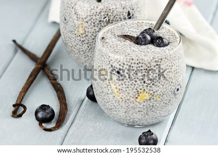 Chia seed pudding made with mangoes and blueberries with extreme shallow depth of field.