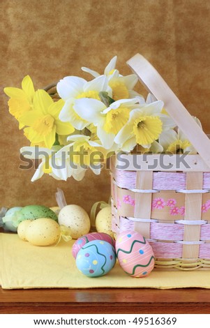 Easter eggs and daffodils in a pretty basket. Shallow DOF.