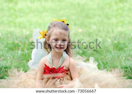 Beautiful happy little girl dressed in a fairy costume.