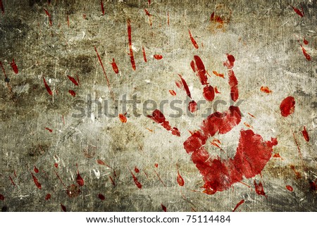 Bloody hand print and blood splatter on a grungy wall.