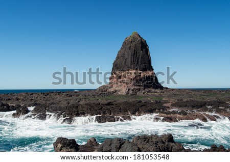 Pulpit Rock at Cape Schanck on the Mornington Peninsula, south-east of Melbourne, Australia.  The rising tide separates the rock from the mainland.