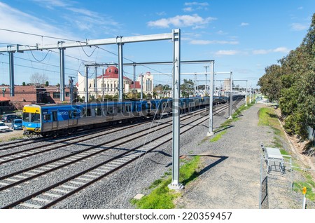 MELBOURNE, AUSTRALIA -  September 21, 2014: local Metro train near Springvale train station. Majority-owned by Hong Kong\'s MTR Corporation, Metro moves 228 million passengers every year.