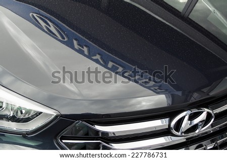 MELBOURNE, AUSTRALIA - November 2, 2014: details of a Hyundai car in a car dealership, with the dealer\'s sign reflected in the bonnet. Hyundai is a large South Korean car manufacturer.