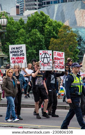 MELBOURNE, AUSTRALIA - November 16, 2014: protesters rallying against the Abbott Liberal government marched down Swanston Street, escorted by police.