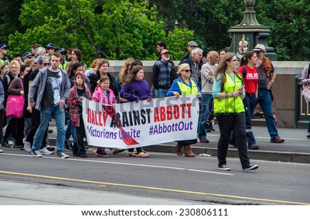 MELBOURNE, AUSTRALIA - November 16, 2014: protesters rallying against the Abbott Liberal government marched down Swanston Street, escorted by police.