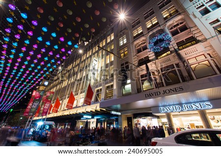 MELBOURNE, AUSTRALIA - December 23, 2014: Christmas lights and crowds in Bourke Street Mall, many lining up in front of the Myer and David Jones stores to view the famous Myer Christmas windows.