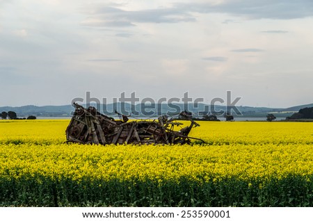 Disused farm machinery in a yellow canola field near Ballarat, Australia