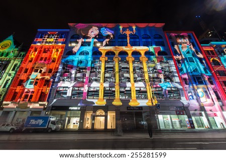 MELBOURNE, AUSTRALIA - February 22, 2015: light projections of scenes from Alice in Wonderland onto the facades of Flinders Street buildings during the White Night arts festival.