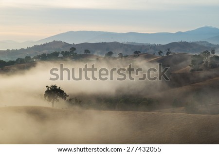 Sunrise over the Goulburn River valley near Alexandra, east of Melbourne, Australia. A low mist hangs over the landscape between the hills.