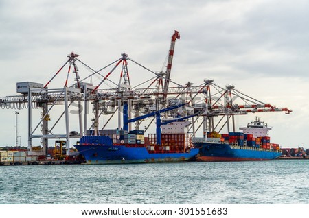 Melbourne, Australia - July 25, 2015: container ships ANL Barwon (front) and ANL Euroa (rear) being unloaded at Swanston Dock in the Port of Melbourne, Australia\'s busiest container port.