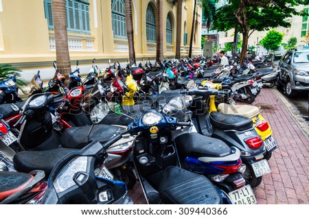 Ho Chi Minh City, Vietnam - August 10, 2015: rows of motorbikes parked outside a public building in Ho Chi Minh City. Motorbikes provide the main means of transport in Vietnam.