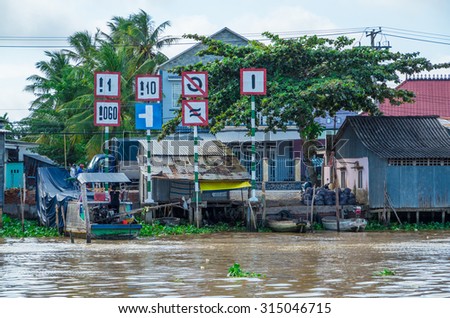 Can Tho, Vietnam - August 12, 2015: buildings and signs crowd the riverbank of the Can Tho River in the Mekong Delta region of southern Vietnam.