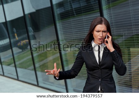 Beautiful bossy business woman on the phone