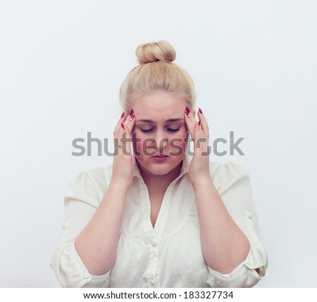 Young woman puts hands on the head, isolated on white. Concept of problems and headache