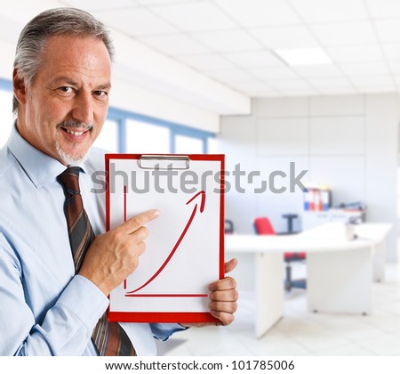 Businessman showing a rising arrow, representing business growth