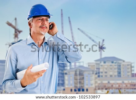 Portrait of a site manager talking at phone