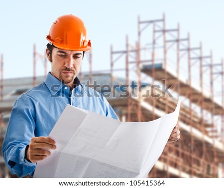 Handsome architect reading a drawing