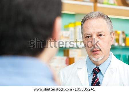 Pharmacist dealing with a customer