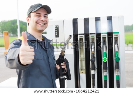 Smiling worker at the gas station giving thumbs up