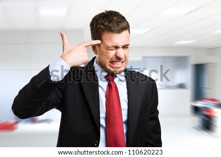Conceptual image of a businessman shooting himself for business problems