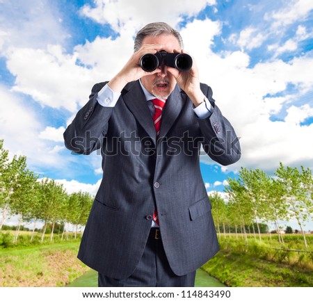 Manager searching for new opportunities using binoculars